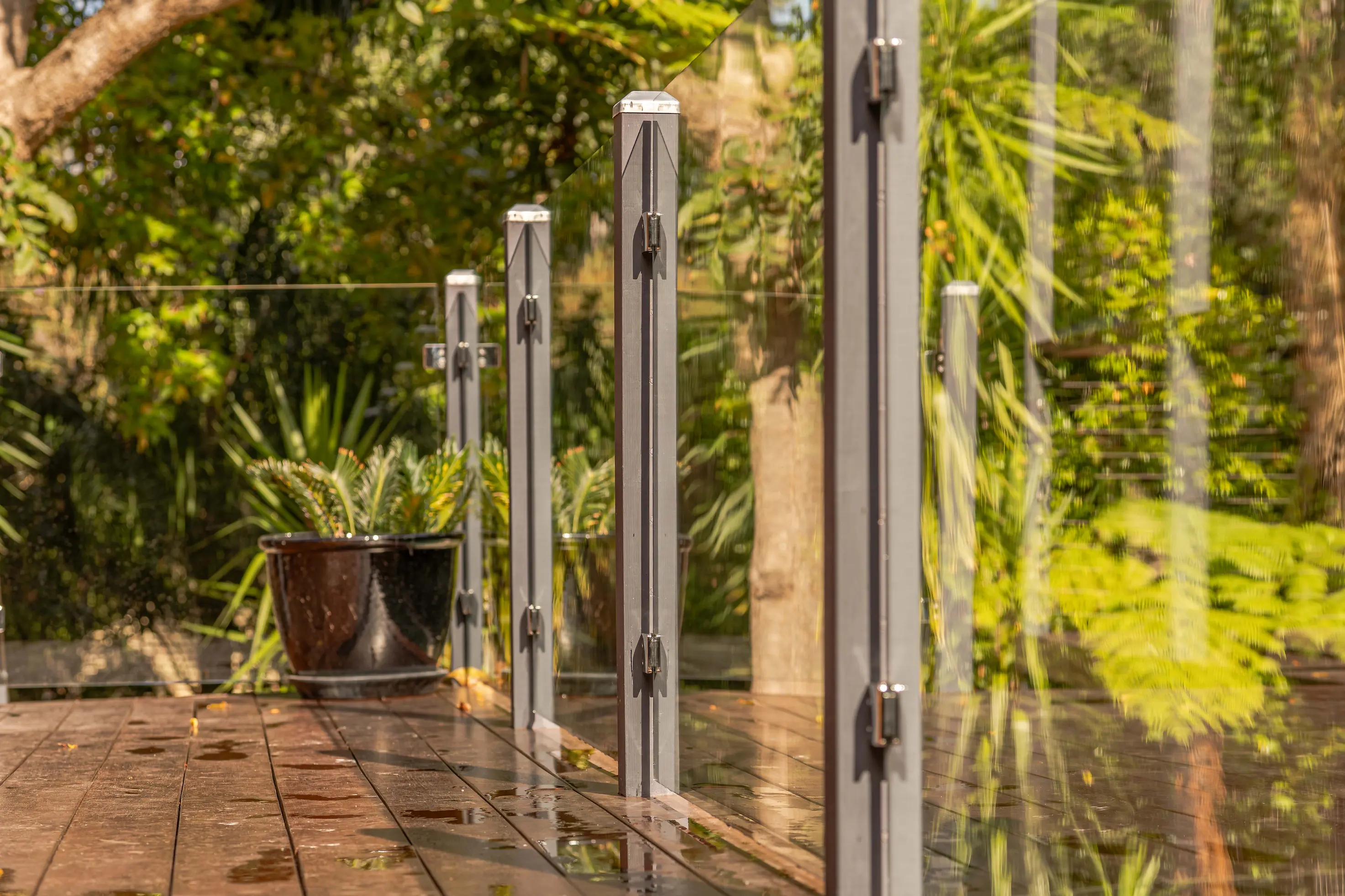 Glass balustrade deck garden wide.